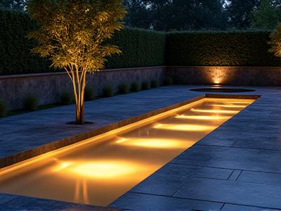 Elegant, custom-designed infinity edge pool flowing into a naturalistic stone basin
